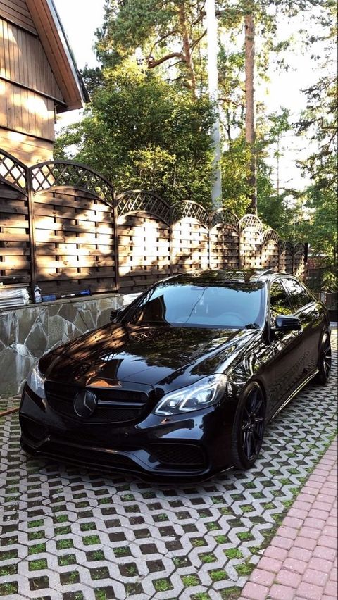 Black Mercedes after a full detail, parked on a paver driveway