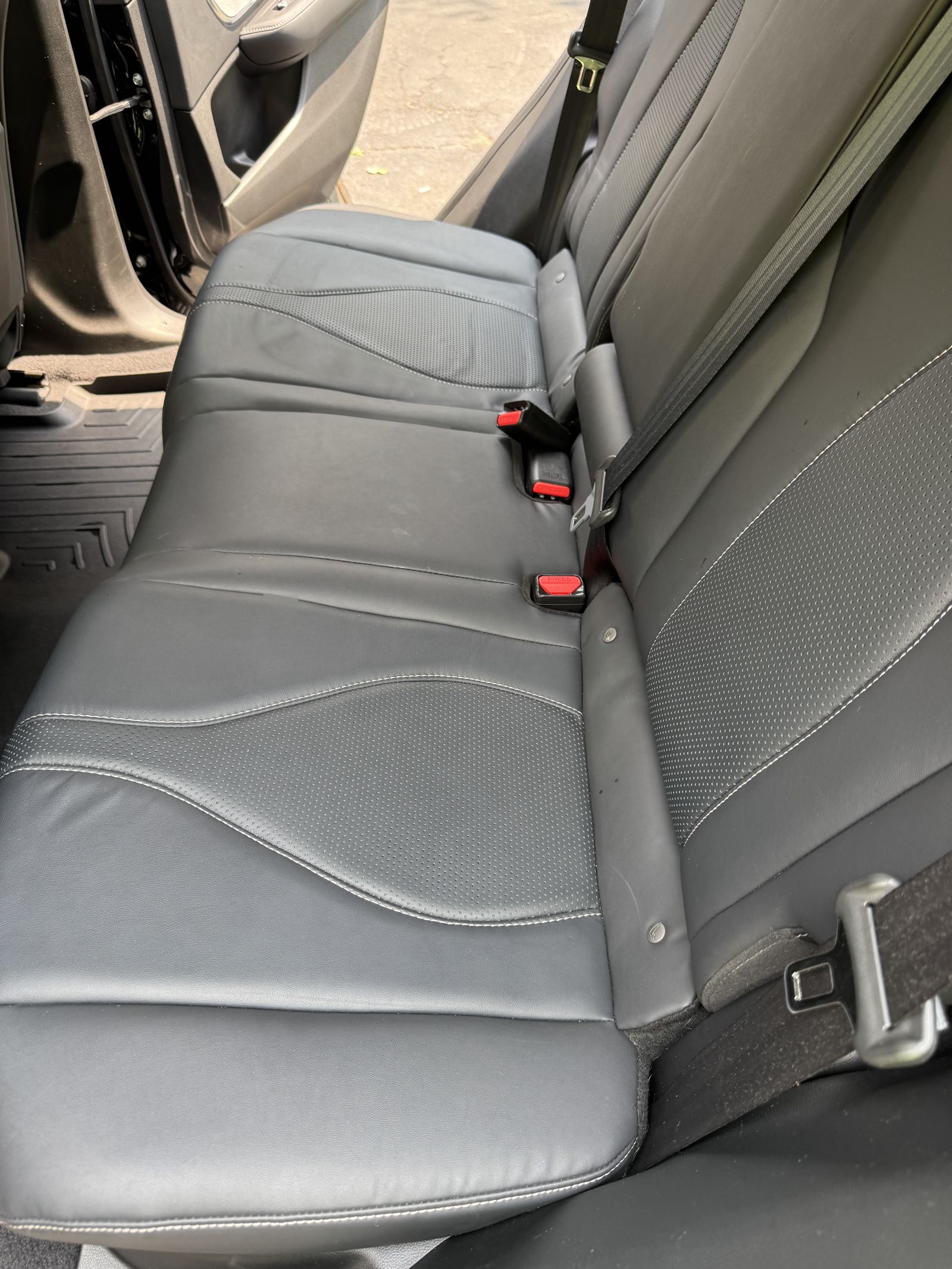The same rear seat after the interior detail, clean leather and a clean floor mat